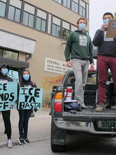 Enrique Balcazar, of Migrant Justice, an advocacy group representing immigrant farmworkers in Vermont, speaks to a crowd outside the federal court in Burlington, Vt.
