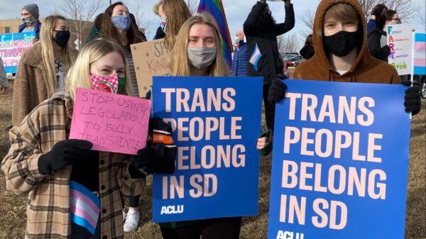 South Dakota Protest Image with people holding "trans people belong in SD" signs
