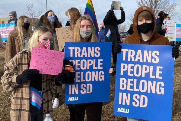 South Dakota Protest Image with people holding "trans people belong in SD" signs
