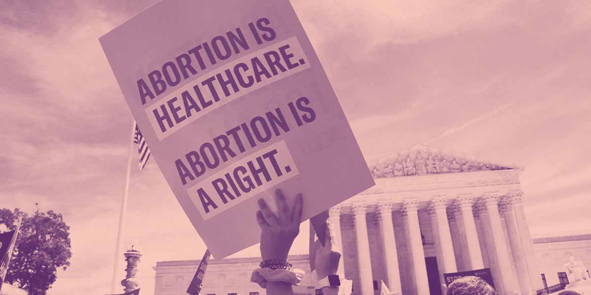 Image of a protest sign that reads, "ABORTION IS HEALTHCARE. ABORTION IS A RIGHT."