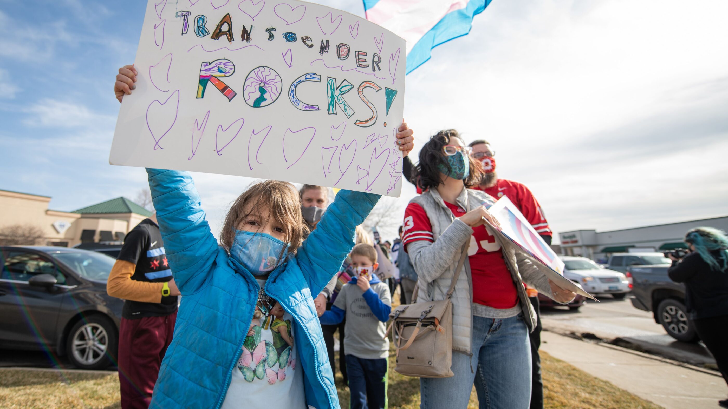 Kid with sign saying Transgender Rocks