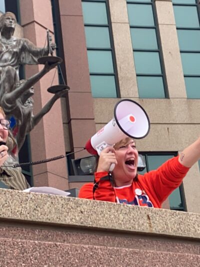 Image of two people speaking at a rally
