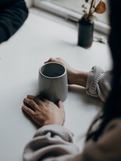 Image of two people at a table having a conversation over coffee