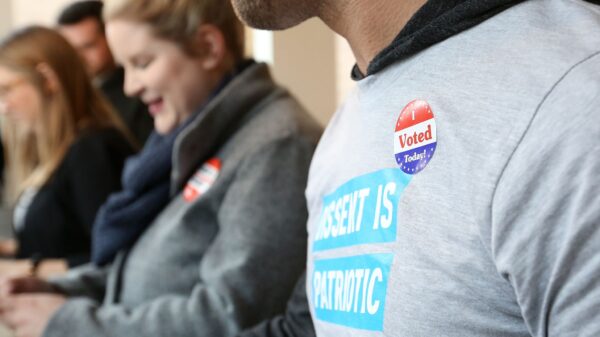 Person with an "I voted" sticker on their shirt.
