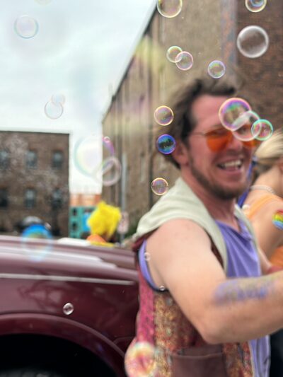 Person showering a crowd with bubbles