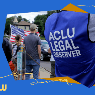 An ACLU of South Dakota legal observer, wearing a blue vest, is working at a protest.