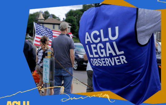 An ACLU of South Dakota legal observer, wearing a blue vest, is working at a protest.