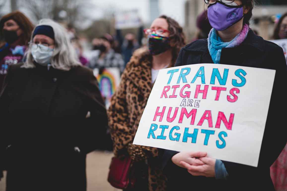 Trans Rights Are Human Rights protest sign held by someone at a rally. 