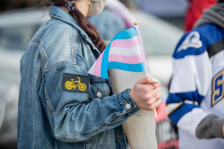protester holding a trans flag