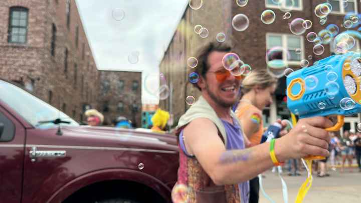 Person showering a crowd with bubbles