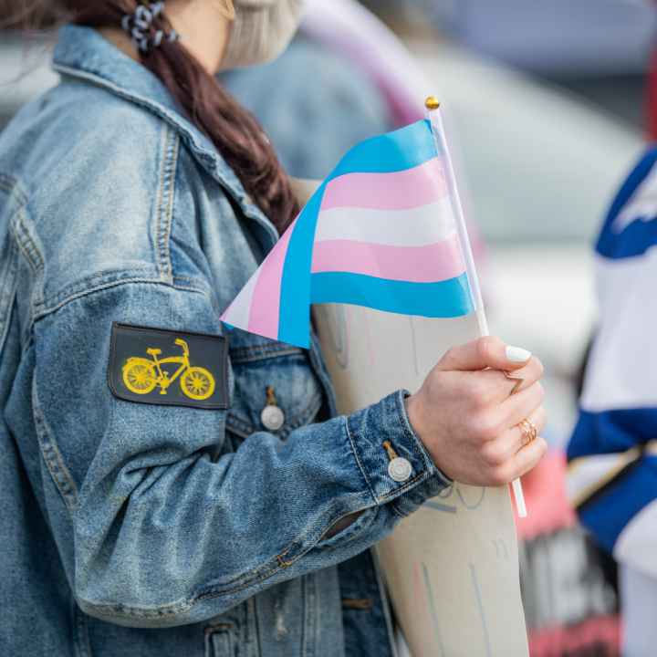 protester holding a trans flag
