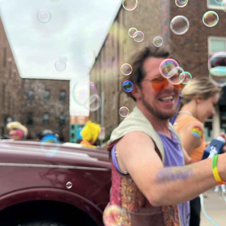 Person showering a crowd with bubbles